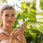 lady with green plants showing sustainability